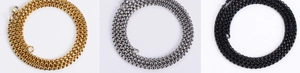 Detailed view of metal box chains in gold, silver, and black finishes on white background