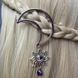 Silver moon hair clip with sun charm and purple stone on blonde braided hair