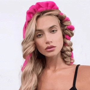 Pink velvet heatless hair curler set for effortless large waves shown on a model