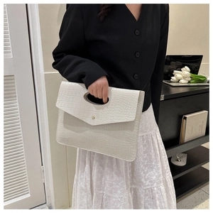 Detailed shot of white crocodile texture envelope clutch bag with unique hollow handle