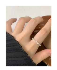 Close-up of minimalist S925 sterling silver bow ring worn on finger with elegant aesthetic
