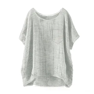 Detail view of grey linen blend top showing round neck, chest pocket and curved high-low hem