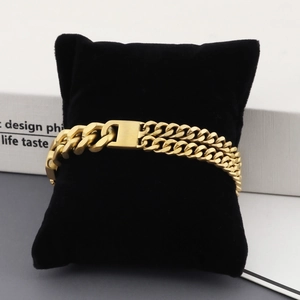 Men's double row Cuban link bracelet in gold-plated stainless steel on display pillow
