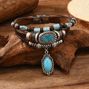 Close-up of bohemian multilayer leather bracelet with wood beads and turquoise charms