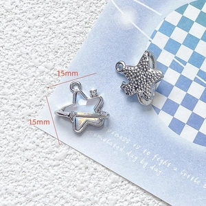 Detail shot of 15mm sea salt blue star and planet charms with rhinestones for DIY jewelry