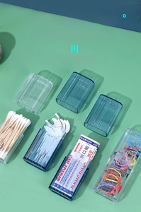 Detailed top view of striped transparent storage boxes for swabs and dental floss
