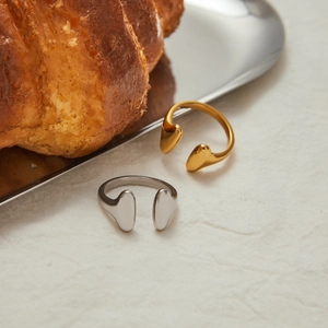 Minimalist adjustable stainless steel rings in gold and silver finish on tray