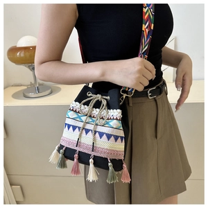 Close-up of ethnic bucket bag featuring colorful embroidery and vibrant tassel details