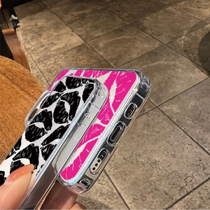 Detail of transparent phone case featuring vibrant zebra and pink abstract art prints