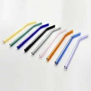 Set of nine colorful curved borosilicate glass straws in a minimalist modern arrangement