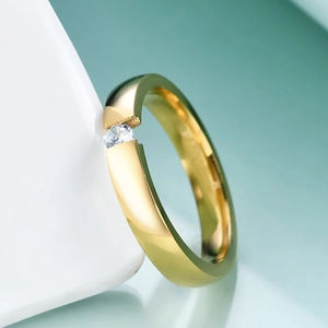 Close-up of 3mm gold stainless steel ring featuring a single sparkling diamond inlay