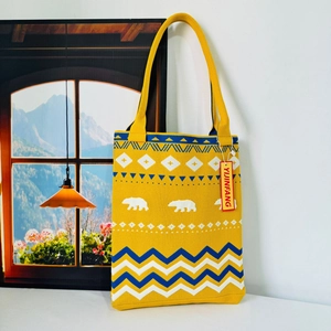 Detail of knitted tote bag with polar bear patterns and geometric blue wave textures