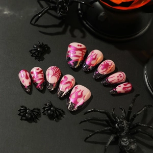Halloween press-on nails featuring magenta flame spider webs and ghost art on black background