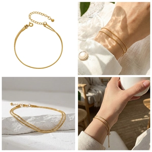 Detail of 18k gold plated double-layer bracelet with snake and bead chains and clasp