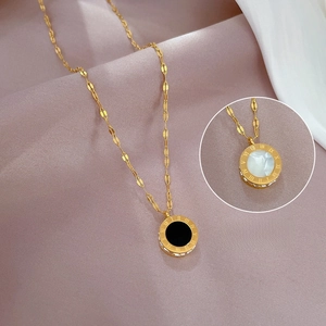 Detail of Roman numeral gold necklace with double-sided black and pearl inlay