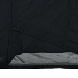 Gros plan sur la texture du tissu en maille noire et les coutures de qualité de la robe