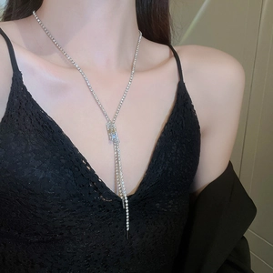 Elegant silver tassel Y-necklace with sparkling zircons shown on a female model