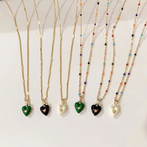 Detail of colorful enamel heart pendants on gold-plated stainless steel chains