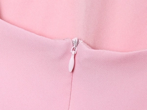 Detail of pink dress featuring a matching invisible zipper and fine fabric texture