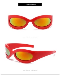 Detail view of red Y2K oval sunglasses with orange gradient lenses and bold side arms
