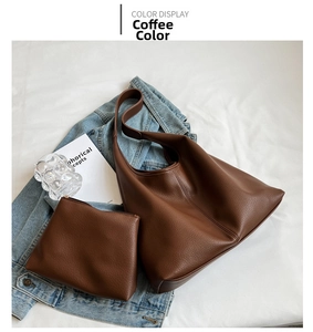 Detail of coffee brown pebble leather bucket bag with matching inner pouch on denim fabric