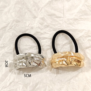Detail showing gold and silver textured metal hair rings with high elasticity bands