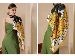 Detail of a large silk scarf showing yellow rose print with black and white block design