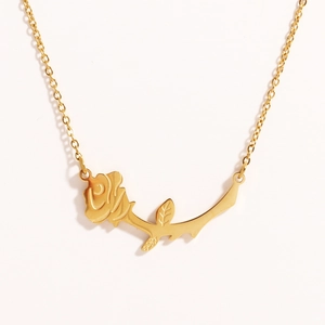 Close-up of golden rose flower pendant with fine chain made of durable titanium steel