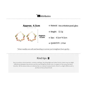 Detail view of colorful beaded hoop earrings with pearls and silver pins, 4.5cm diameter