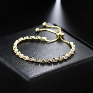 Macro view of gold marquise cut zircon tennis bracelet with adjustable sliding closure