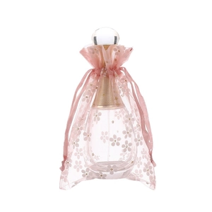 Floral print organza drawstring gift bag with glass perfume bottle and ribbon tie