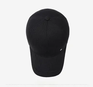 Top view of a thick black winter baseball cap with fine knit texture and metal accent