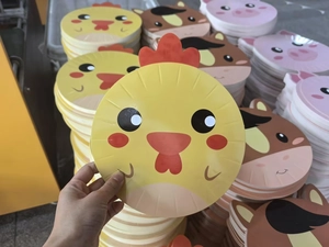 Detail of yellow chick shaped paper plate for farm themed children birthday parties