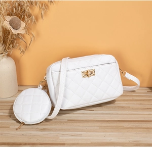Detalle de bolso bandolera blanco acolchado con monedero pequeño y cierre dorado