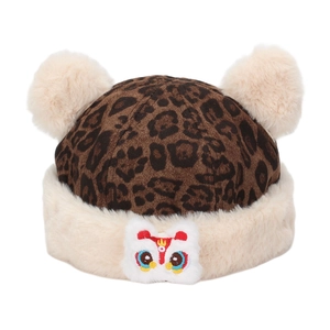 Detail of winter leopard print hat with fluffy pom-poms and lion dance embroidery