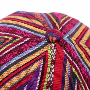 Detailed macro view of vibrant bohemian woven patterns on top of the colorful baseball cap