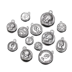 Detail of vintage silver alloy coin pendants for DIY jewelry making with queen head motifs