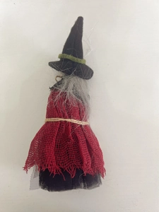 Close-up of Halloween witch doll with red mesh skirt and grey hair hanging decor