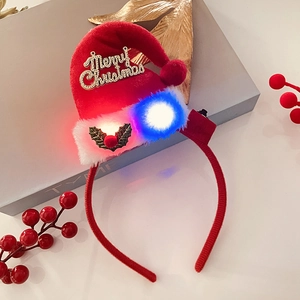 Detail of red plush Christmas hat headband with glowing LED lights and Merry Christmas text