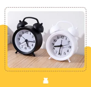 Detailed view of the twin bell alarm clock featuring a matte metal shell and quartz movement