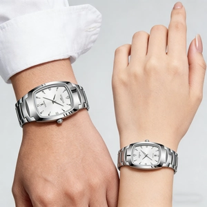 Detail of silver tonneau quartz couple watches with metal straps worn by a model