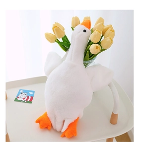 Detailed view of plush white goose bag with soft fur texture and orange beak detail