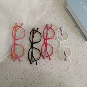 Flat lay of colorful kids' fashion glasses frames in pink, black, rose and white