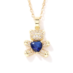 Golden bear pendant necklace featuring a blue heart zircon and sparkling micro-pave crystals