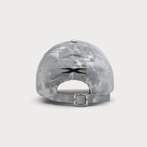 Detailed back view of a grey tie-dye baseball cap with black X embroidery and silver buckle