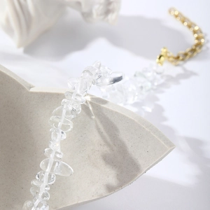 Detail of bohemian natural clear crystal stone bracelet with adjustable gold chain