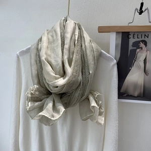 Close-up of beige linen scarf featuring delicate lace trim and soft breathable texture