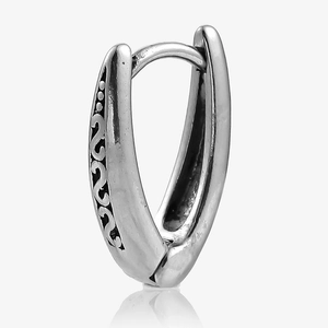 Detail of vintage silver V-shaped earrings with black hollowed-out engraving and floral patterns