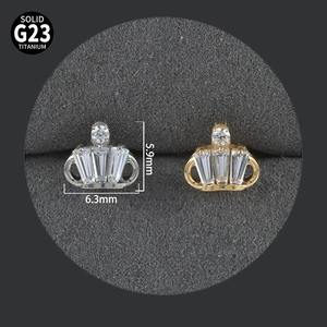 Detailed macro view of G23 titanium crown studs with zircons in silver and gold colors
