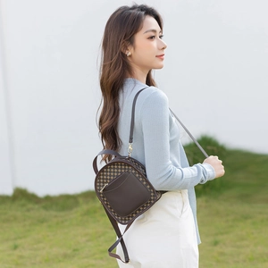 Vintage dark brown women's backpack with geometric patterns in an outdoor setting